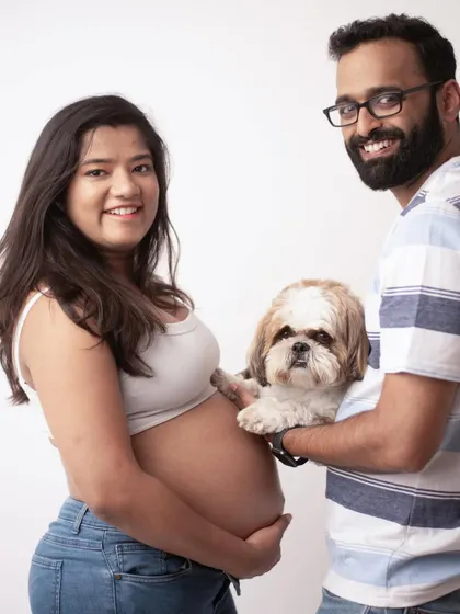 Fur babies are family too. This adorable portrait includes the couple's beloved dog, making it a complete and heartwarming family photo.