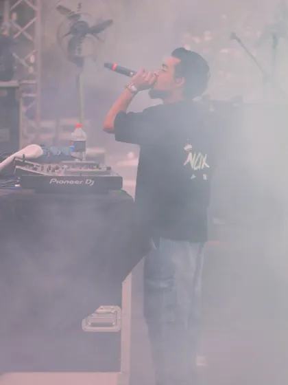 A candid shot from JLN Stadium, surrounded by stage smoke. I perform in all conditions, focused on delivering a powerful set of hip hop, DHH, and commercial tracks.