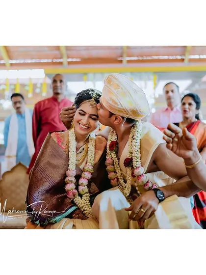 A sweet kiss for the bride during the wedding rituals.