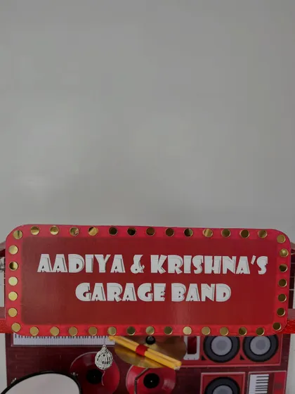 A close-up of the personalized 'Aadiya & Krishna's Garage Band' marquee sign.