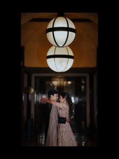 A romantic dance portrait of the couple, framed by the beautiful interior lighting of their Sangeet venue.