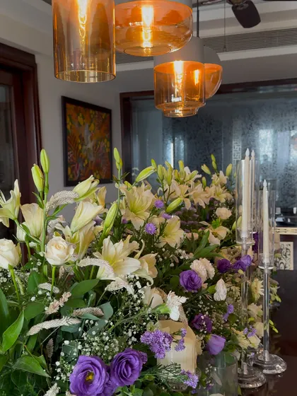 A beautiful shot of our floral centerpiece under modern amber glass pendant lights, showing how our decor works with different interior styles.