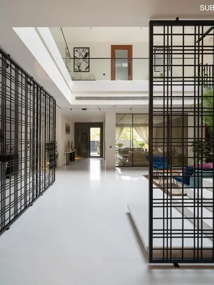 These symmetrical partitions act as both functional dividers and decorative screens, adding visual interest and a sense of rhythm to the contemporary interior.