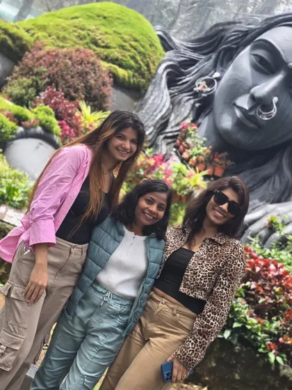 Friends posing at the Adiyogi statue in Chikmagalur. Our trips are full of picture-perfect moments and new profile pictures.