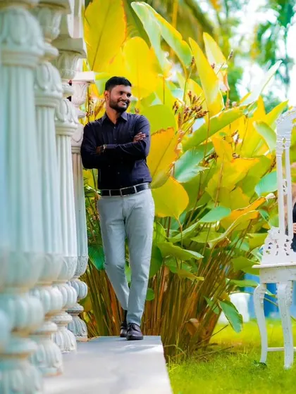 A behind-the-scenes style shot showing the couple interacting with a prop mirror in a garden. This adds a fun and unique perspective to the shoot.