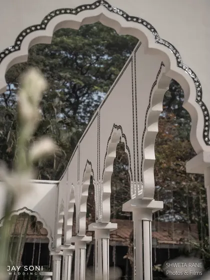 A detail shot of the intricate black and white inlay work on the arches of the lounge pavilion, showcasing the high level of craftsmanship.