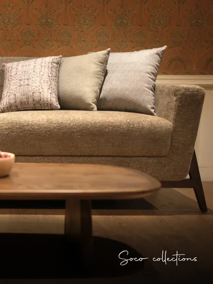 The Soco collection sofa in a textured beige fabric, paired with a solid wood coffee table. This combination creates a warm, soft, and inviting atmosphere.