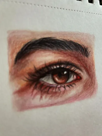 Another angle of the color pencil eye drawing, showing the texture of the paper.