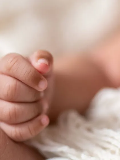 It's the little things that you'll want to remember forever. This close-up shot focuses on the delicate, tiny fingers of a newborn, capturing the fleeting details that make this time so precious. We believe these macro detail shots are an essential part of any newborn gallery.