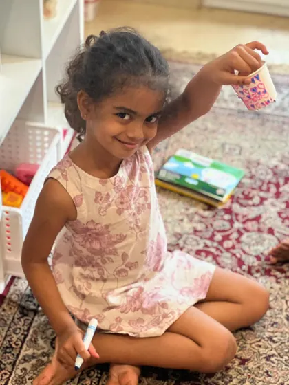 A happy girl showing off the dress-changing doll she designed. This interactive craft was a huge success.