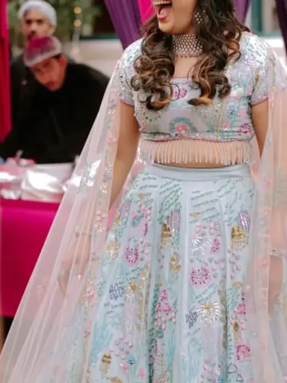 The bride's joyous laughter captured mid-dance at her Sangeet. We create the atmosphere, so you can create the memories.