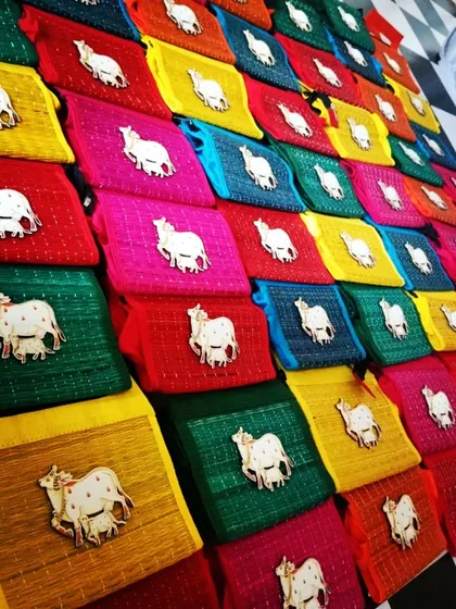 A beautiful array of our Pichwai cow shagun pouches in various colors. These are a vibrant and popular choice for return gifts.
