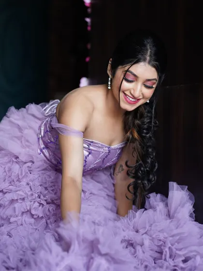 A playful and dynamic pose showing the incredible volume and texture of the lavender gown's multi-layered skirt.