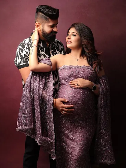 A stylish couple's portrait against a rich, warm backdrop. The way they look at each other tells a beautiful story.