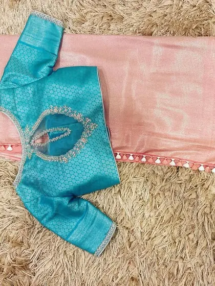 A unique combination of a cherry blossom pink saree with a Hawaiian ocean blue brocade blouse.