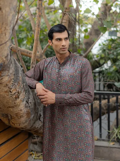 The fine details of the print are visible in this shot. The blend of colors creates a tapestry like effect, showcasing a sophisticated approach to printed menswear.