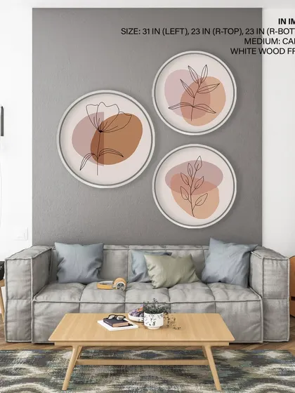 This triptych of circular prints showcases simple botanical line art against earthy, abstract shapes. The white wood frames add to the clean, contemporary aesthetic.
