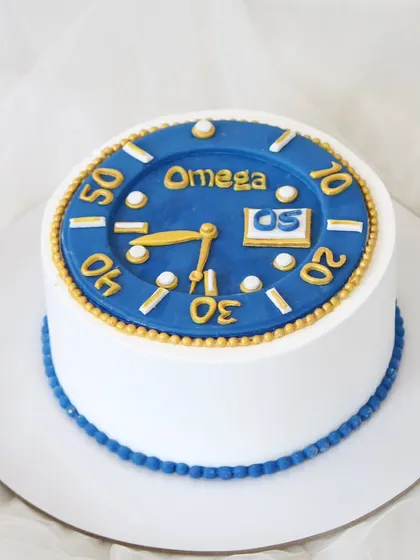 A sleek and stylish cake featuring an Omega watch face design. The details of the watch are meticulously recreated with fondant, making it the perfect surprise for a watch enthusiast.