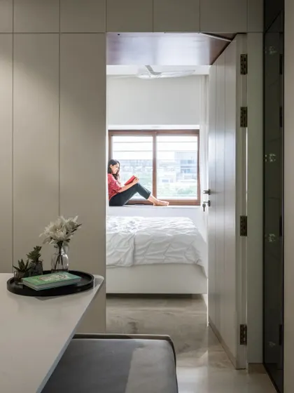 Another perspective showing the view from the dining table into the tranquil bedroom space, highlighting the home's thoughtful layout and flow.