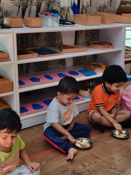 Children enjoying the food they helped prepare. Eating together is an important social grace, and it's even more special when they can take pride in having made the meal themselves.