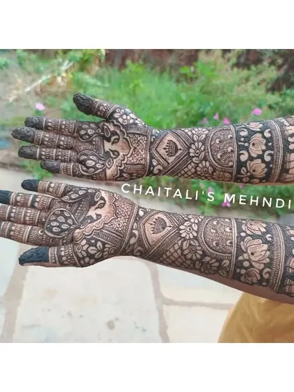This is a side view of a traditional bridal mehendi design. You can see the detailed elephant motifs at the elbow and the intricate floral and geometric patterns covering the arm.