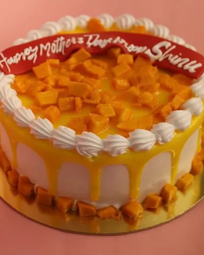 Another angle of our special Mother's Day Mango Cake, showing the beautiful mango drip glaze.