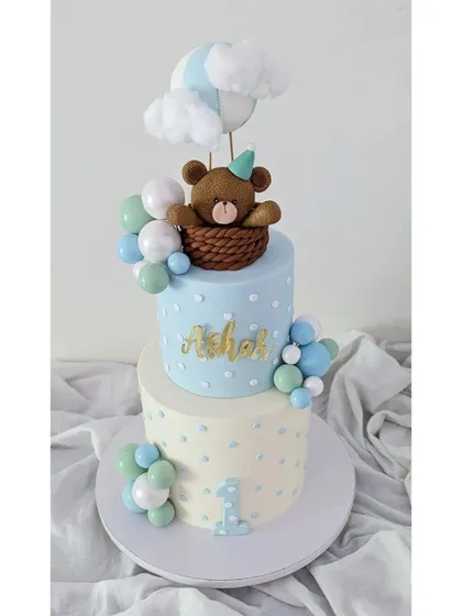 Up, up, and away! This hot air balloon cake, with a cute teddy bear in a basket, was made for Ashar's first birthday. I also made his baby shower cake, and I love being part of these journeys.