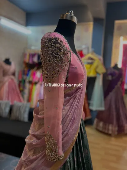 A close-up of the embroidered full sleeves on a pink and grey lehenga.