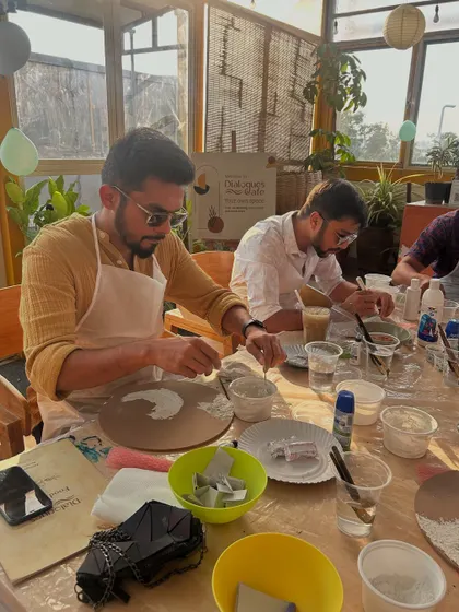 Two participants focused on their beach paintings. The workshop is a great way to unwind and de-stress.