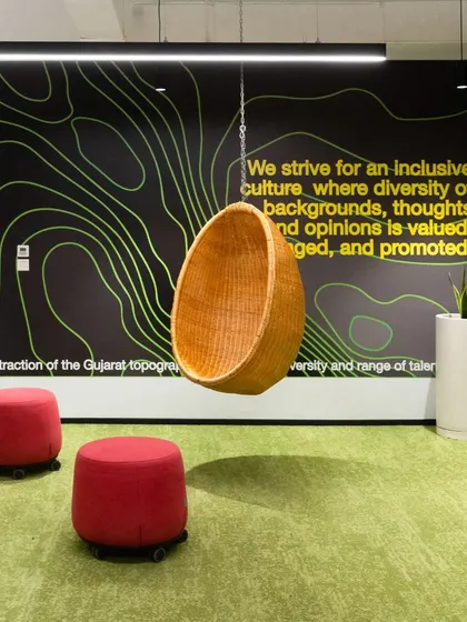 For a multi-national client, we integrated environmental graphics that reflect the local context, such as this abstract representation of Gujarat's topography. This approach ensures that even global offices have a unique sense of place and an inclusive culture.