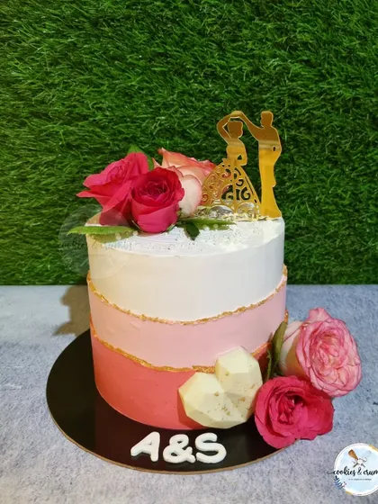 This ombre cake in shades of pink was for an intimate wedding reception. I used a couple silhouette topper and fresh roses to create a romantic design, and the flavor inside was my popular Mango Tango.