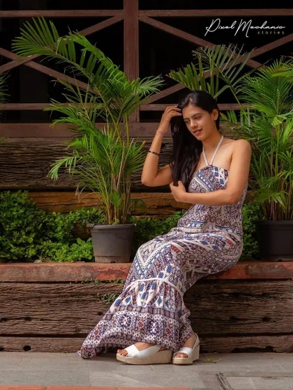 The bohemian-print jumpsuit and the urban garden setting come together for a chic and breezy lifestyle portrait. This is a great look for a relaxed afternoon shoot.