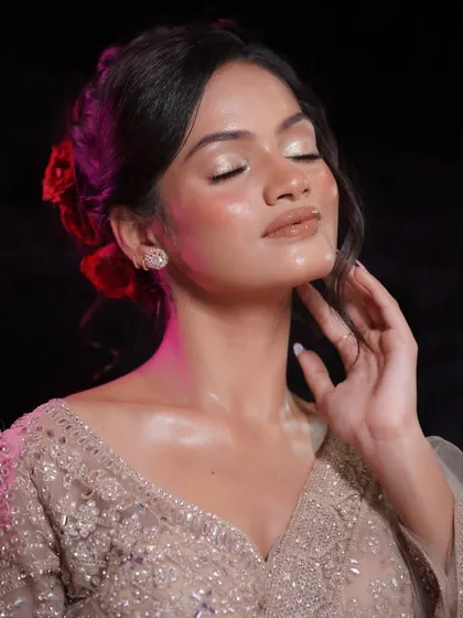 A serene shot that captures the ethereal quality of the glass skin makeup. The soft hairstyle with red roses complements the dewy, romantic vibe.