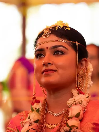 A beautiful candid of the bride looking up during the rituals. The makeup is waterproof and designed to withstand the emotions and length of a wedding day.