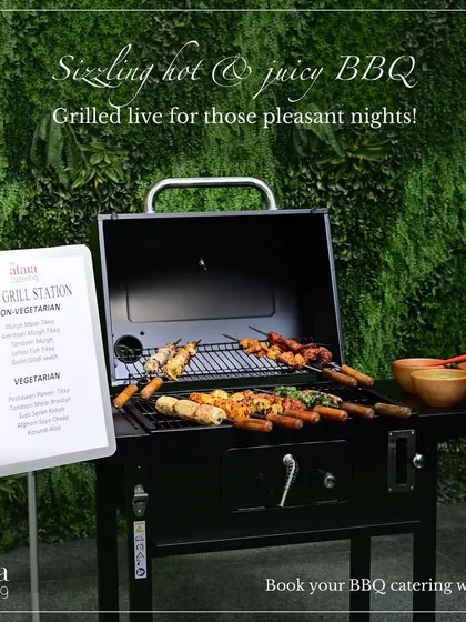 Our live grill station set up for a pleasant evening event. The menu board displays the vegetarian and non-vegetarian options available, including various tikkas and kebabs.