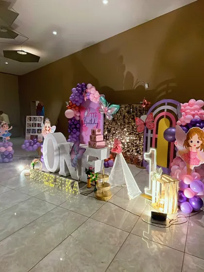 Another perspective of the butterfly party, highlighting the lit-up props and the way the decor fills the space to create an immersive, magical environment.