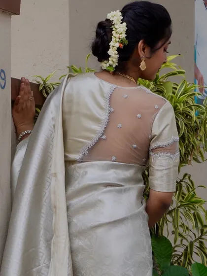 Here's another angle of the beautiful sheer back blouse. You can see the craftsmanship in the placement of the net and the fine embroidery along the edges. It's a perfect example of a modern designer blouse.