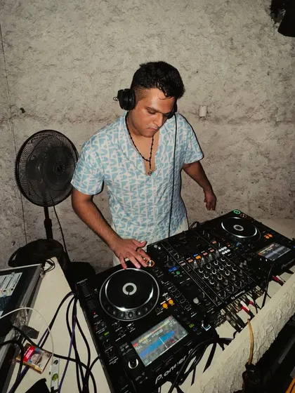 Another angle from behind the decks, showing my complete focus on the equipment and the music.