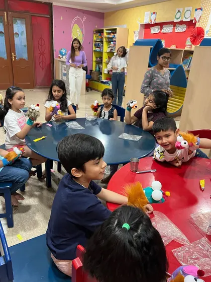 A wide shot of the puppetry camp in action. You can see the kids are completely absorbed in creating and playing with their puppets.