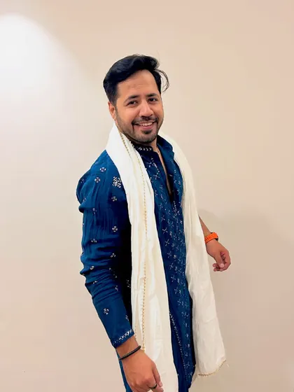 A simple, smiling portrait in the blue kurta. This look is versatile and works for a variety of cultural events.
