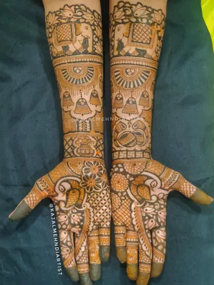 This bridal henna is filled with traditional elements like elephants, temple bells, and auspicious symbols.