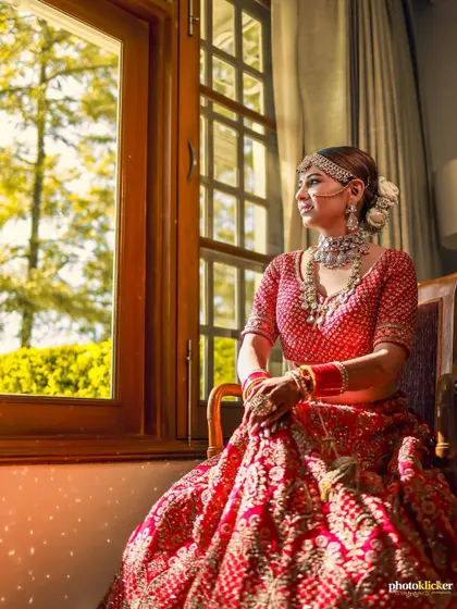 A serene bridal portrait by the window, capturing the bride in a moment of quiet contemplation on her wedding day.