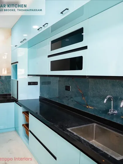 This angle highlights the sleek, handleless design of the light blue cabinets. The glossy surface and minimalist hardware contribute to a clean and uncluttered look, perfect for modern homes.