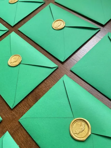 There's something so elegant and timeless about a perfectly sealed envelope. I love using different colors, from vibrant orange and green to classic grey vellum, each finished with a custom wax seal.