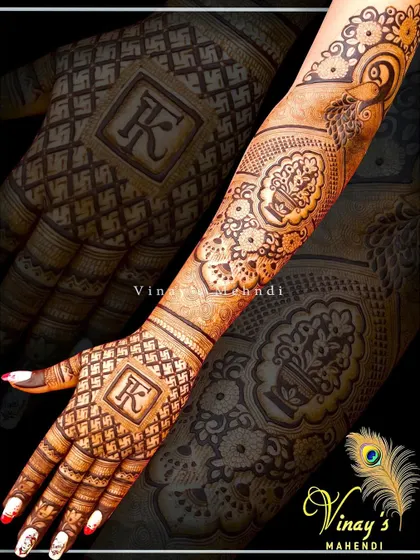 A personalized back-hand design with the initial 'K' and a pot (kalash) motif, symbolizing prosperity.