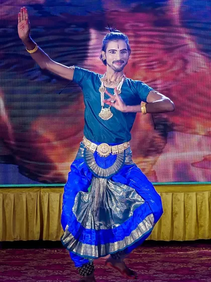 A male classical dancer captured mid-performance on stage. Our photography focuses on capturing the energy, expression, and intricate details of the costume and pose.
