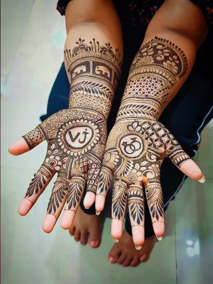 For this engagement mehandi, I included the couple's initials 'VJ' in a circle on one palm and a symbol of interlocking rings on the other.