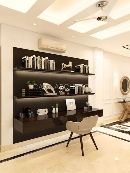 A minimalist floating desk and shelving unit in a dark wood finish, creating a sleek and functional workspace within an open living area.