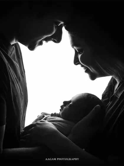 A high-contrast silhouette of a new family. This black and white image is a powerful and artistic representation of their new bond.