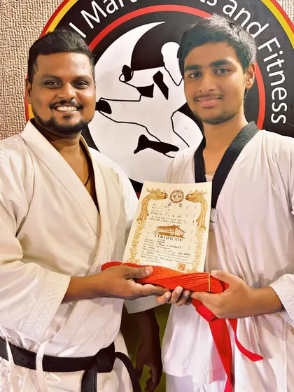 Moving up the ranks. This student has earned his red belt in Taekwondo, a significant achievement.